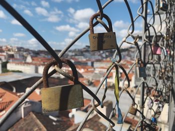 Close-up of padlocks on chainlink fence