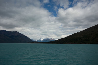 Scenic view of sea and mountains against sky