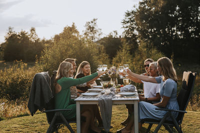 Group of people sitting on table at field