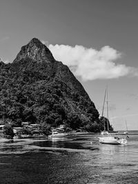 Sailboats sailing on sea against sky