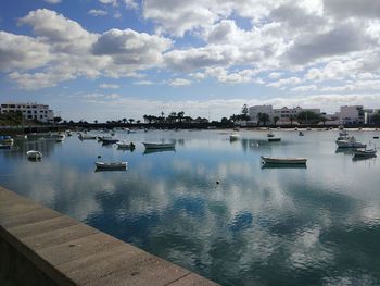 Scenic view of harbor against sky in city