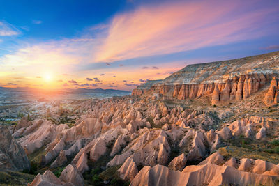 Panoramic view of rock formations against sky during sunset