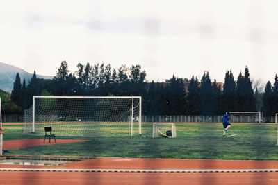 People playing with ball against the sky