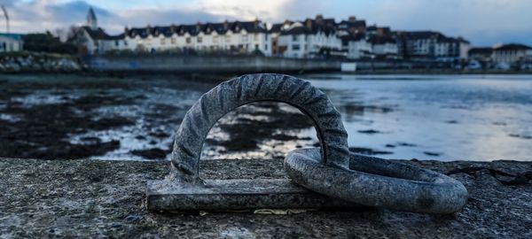 Close-up of metallic rings at beach