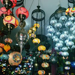 Low angle view of illuminated lanterns hanging in store