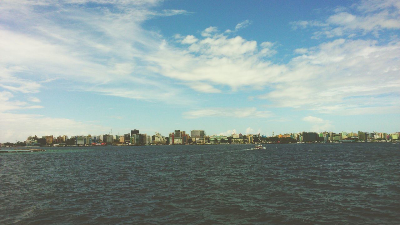 water, waterfront, sky, building exterior, architecture, built structure, sea, cloud - sky, rippled, city, cloud, river, cityscape, scenics, tranquil scene, tranquility, nature, day, outdoors, beauty in nature