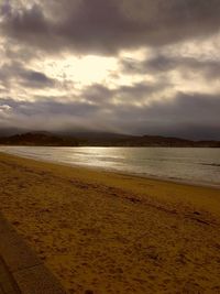 Scenic view of beach against sky during sunset