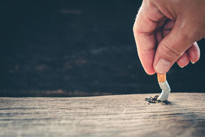 Close-up of person holding cigarette