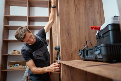 Side view of young woman working at home