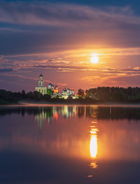 Scenic view of lake against sky during sunset