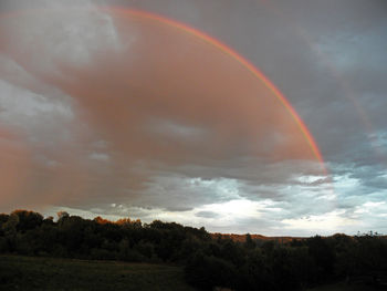 Rainbow over landscape against sky