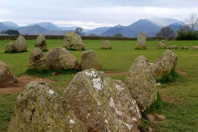 Scenic view of rocks on field against sky