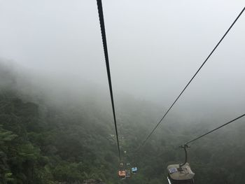 Overhead cable car in foggy weather