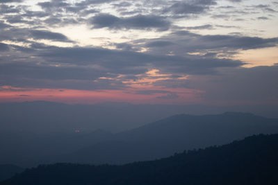 Scenic view of silhouette mountains against sky during sunset