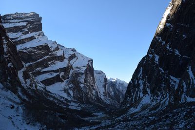 Low angle view of mountain against clear blue sky