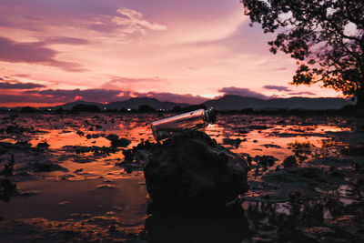 Scenic view of rocks against sky during sunset