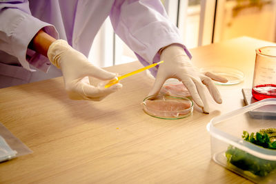 Midsection of woman working on table