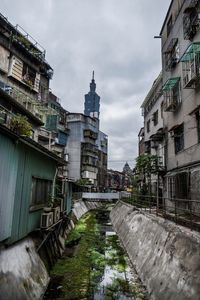 Street amidst buildings in city against sky