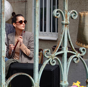 Portrait of man wearing sunglasses sitting outdoors