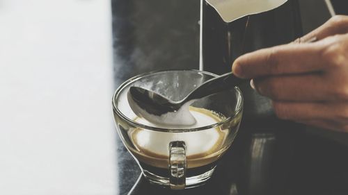 Midsection of person preparing food in glass