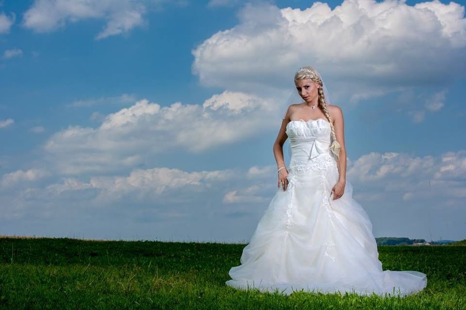 person, grass, sky, casual clothing, front view, young adult, lifestyles, leisure activity, field, standing, smiling, young women, portrait, three quarter length, looking at camera, full length, cloud - sky, day