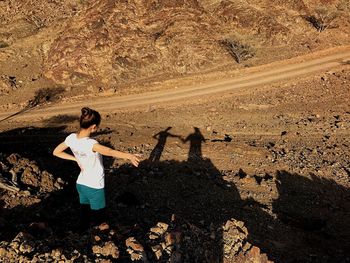 High angle view of woman standing on rock