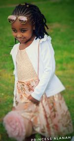 Cute girl smiling on field