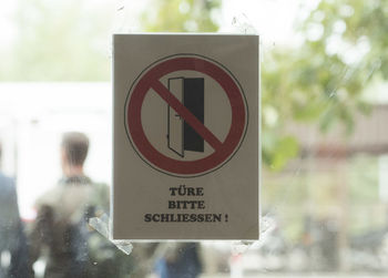 Close-up of road sign against trees