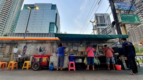 Rear view of people working in city