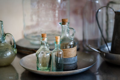 Close-up of bottle in metallic plate on table