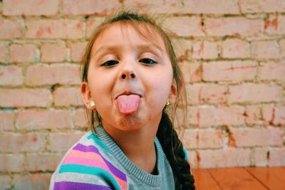 Close-up of portrait of girl sticking out tongue