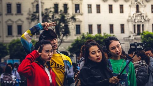 Portrait of young couple standing in city