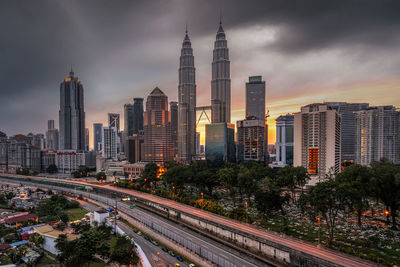 Panoramic view of buildings against cloudy sky