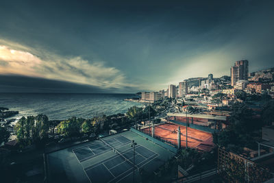 High angle view of buildings by sea against sky