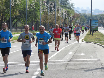 People running on street in city