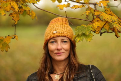 Portrait of smiling woman with autumn leaves