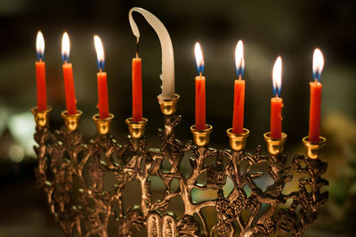 Close-up of lit candles on candlestick holder
