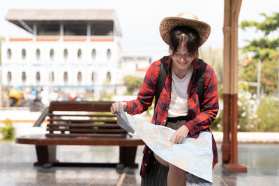 Portrait of young woman with map