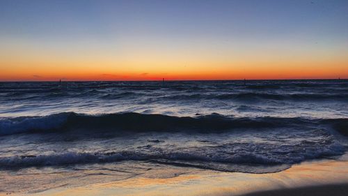 Scenic view of sea against clear sky during sunset