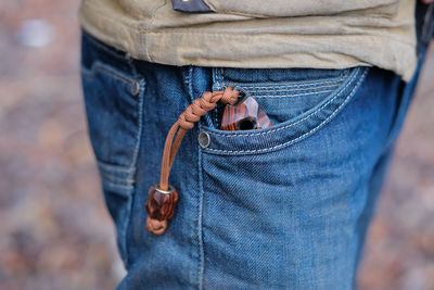 Midsection of man holding rope