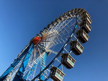 Low angle view of ferris wheel against sky