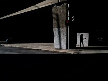 Bridge over sidewalk at night