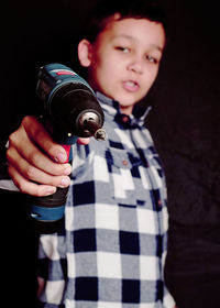 Portrait of a boy holding camera