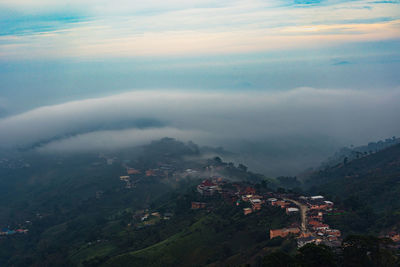 Beautiful landscape of mountain layer in morning sun ray and winter fog at mae salong nai, chiangrai