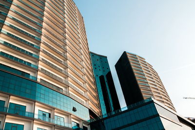 Low angle view of modern buildings against clear sky