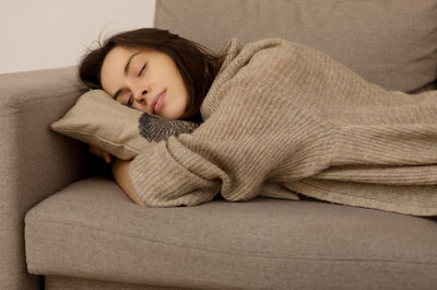 Portrait of woman sleeping on sofa
