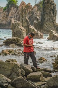 Rear view of man standing on rock