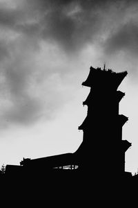 Low angle view of building against cloudy sky