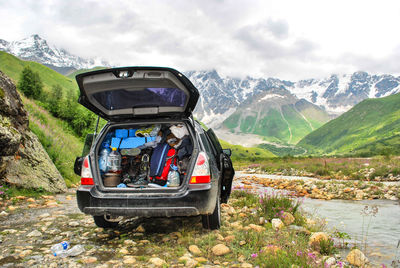 View of car on landscape against mountain range