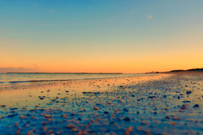 Scenic view of sea against clear sky during sunset